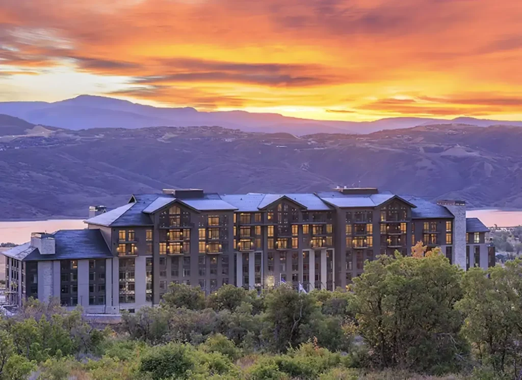 Grand Hyatt Deer Valley, Utah with color-filled mountains and sunset background