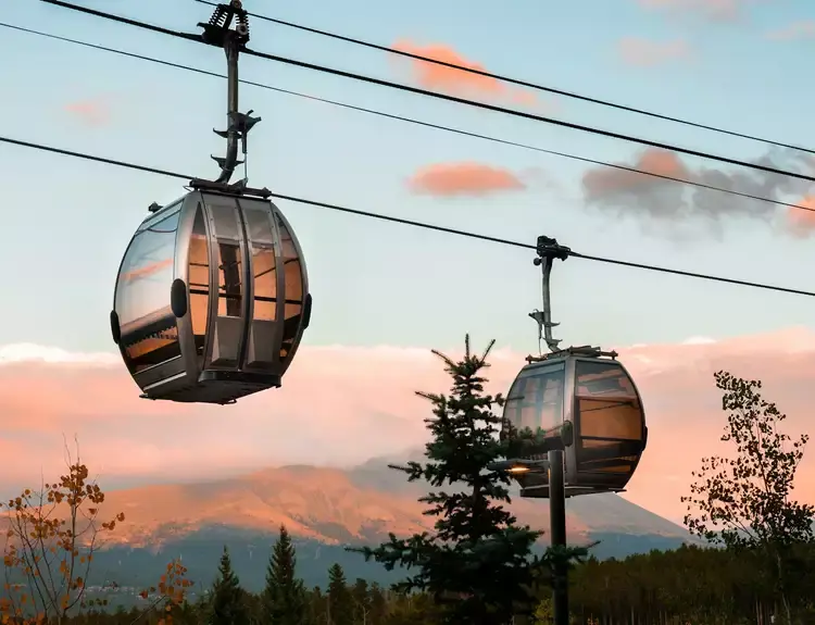 Two Gondola traveling up and down the lines in Steamboat Spring