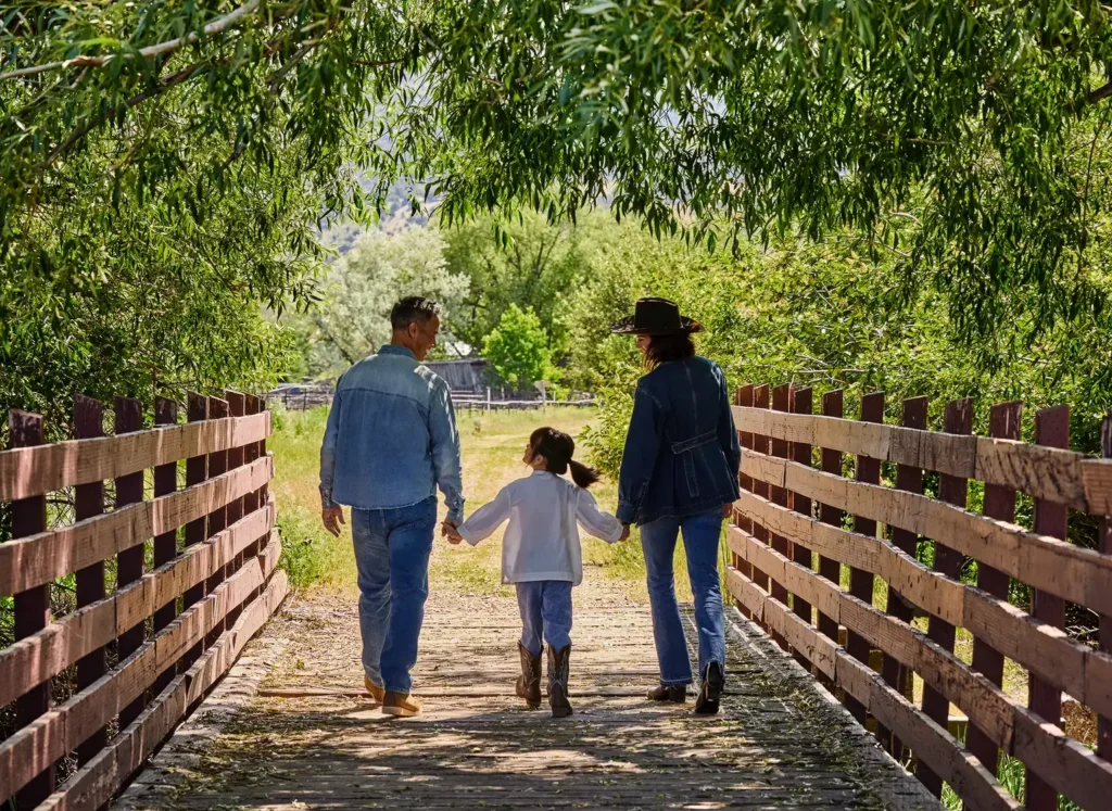 Stockman Steamboat: Three people, Family, Mom, Dad, and Kid at the Ranch