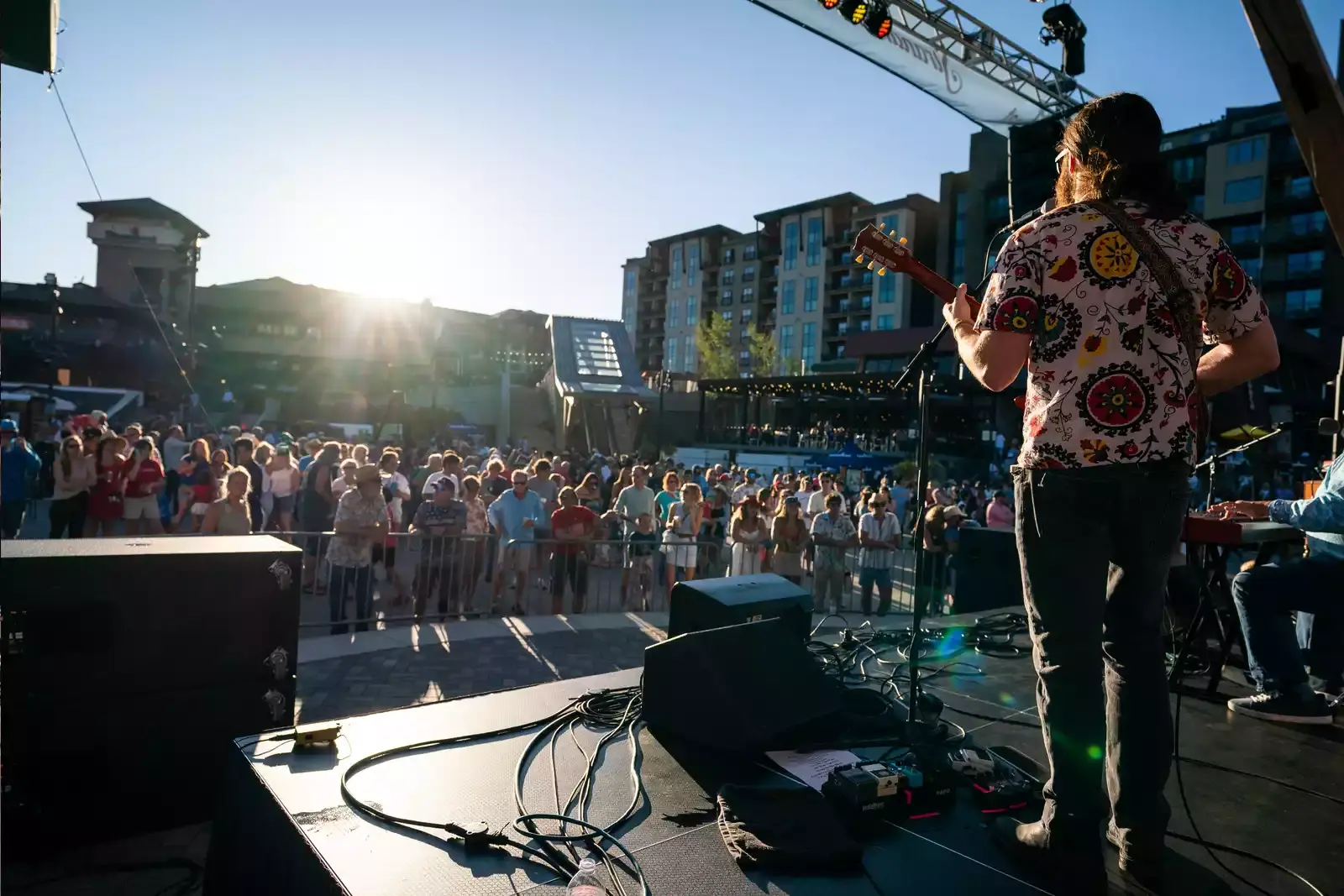 Guitar Artist Back Stage view, while he entertains the public in the Steamboat Springs music fest
